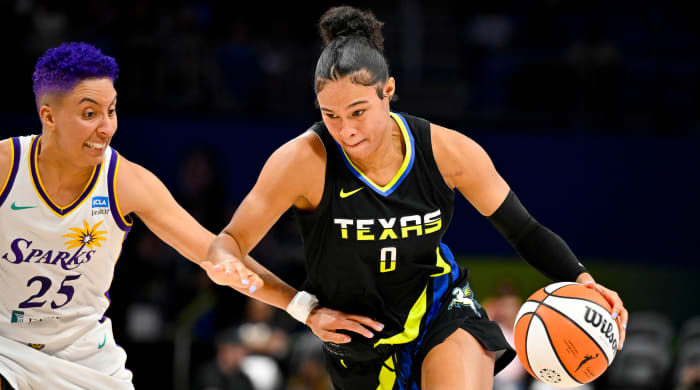 Wings forward Satou Sabally dribbles and drives to the basket past Sparks guard Layshia Clarendon.
